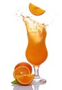 Splash in glass of alcoholic tropical cocktail drink with falling slice of orange Royalty Free Stock Photo