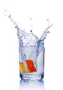 Splash in glass of blue water with orange slice Royalty Free Stock Photo