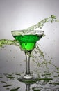 Splash in glass of green alcoholic cocktail drink Royalty Free Stock Photo