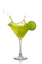 Splash in glass of green alcoholic cocktail drink with lime Royalty Free Stock Photo