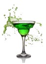 Splash in glass of green alcoholic cocktail drink Royalty Free Stock Photo