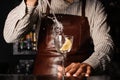 Splash in a glass with lemon barman on background Royalty Free Stock Photo