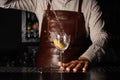 Splash in a glass with lemon barman on background Royalty Free Stock Photo