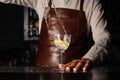 Splash in a glass with lemon barman on background Royalty Free Stock Photo