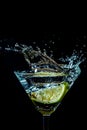 splash in a glass with lime slice on a black