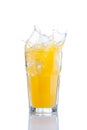 Splash in glass of orange soda with ice cubes Royalty Free Stock Photo