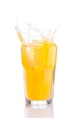 Splash in glass of orange soda with ice cubes