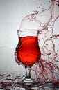 Splash in glass of red alcoholic cocktail drink Royalty Free Stock Photo