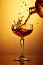 Splash in high glass with whiskey, rum, brandy or gin over golden warm gradient background.