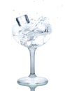 Splash from ice cube in a wine glass of water Royalty Free Stock Photo