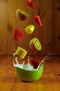 Splash milk with fruit flying and streeting on a wooden background Royalty Free Stock Photo