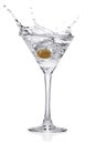 Splash from olive in a glass of cocktail. Royalty Free Stock Photo