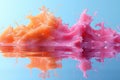 a splash of orange and pink liquid in a glass of water Royalty Free Stock Photo