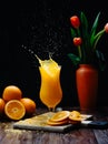 Splash of orange slice in orange juice Royalty Free Stock Photo