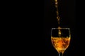 Splash orange water into a crystal wine glass, closely spreading Royalty Free Stock Photo