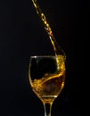 Splash orange water into a crystal wine glass, closely spreading Royalty Free Stock Photo