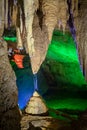 Splashes of water from a stalactite creating a stalagmite beneath it in a cave.