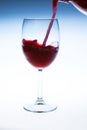 Splash red wine glass against a white background Royalty Free Stock Photo