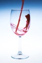 Splash red wine glass against a white background Royalty Free Stock Photo