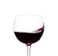Splash of red wine in a glass isolated on  white Royalty Free Stock Photo