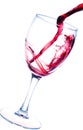 Splash of red wine in glass isolated on white Royalty Free Stock Photo