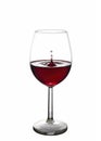 Splash of red wine in a glass on a white background Royalty Free Stock Photo