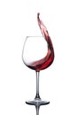Splash of red wine in a glass on a white background. Royalty Free Stock Photo