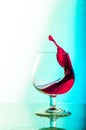 Splash of red wine in a glass. White Background Royalty Free Stock Photo