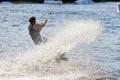 Splash of silver water splashes after a wakeboarder`s sharp turn on the water surface of a river Royalty Free Stock Photo