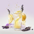 Splash of three glasses lavender lemonade with lemon on purple background Royalty Free Stock Photo