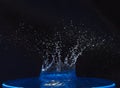 Splash of water crown on blue surface. Royalty Free Stock Photo