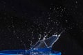 Splash of water crown on blue surface. Royalty Free Stock Photo