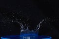 Splash of water crown on blue surface. Royalty Free Stock Photo