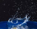 Splash of water crown on blue surface. Royalty Free Stock Photo