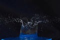 Splash of water crown on blue surface. Royalty Free Stock Photo