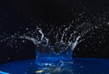 Splash of water crown on blue surface. Royalty Free Stock Photo