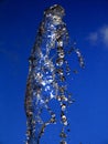 Splash of water frozen in time under a dark blue sky Royalty Free Stock Photo