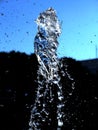 Splash of water frozen in time under a dark blue sky Royalty Free Stock Photo