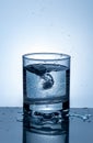 Splash of water in a glass. Splashing water. Ice water. Concept. Royalty Free Stock Photo