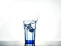 Splash of water with ice in a glass Royalty Free Stock Photo