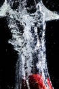 Splash of water with red apple and black background Royalty Free Stock Photo
