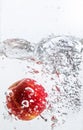 Splash of water with red apple and white background Royalty Free Stock Photo