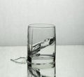 Splash of water in a whisky glass Royalty Free Stock Photo