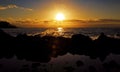 Splash of wave over rocks in the sunrise