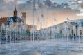 Splashes of a fountain against the backdrop of the city and a be Royalty Free Stock Photo