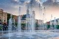 Splashes of a fountain against the backdrop of the city and a be Royalty Free Stock Photo