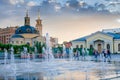 Splashes of a fountain against the backdrop of the city and a be Royalty Free Stock Photo