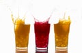 Splashes on glasses of orange juice and strawberry juice Royalty Free Stock Photo