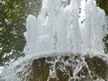 Splashes and jets of the fountain in the city park. A fountain with splashes and drops of water works. Royalty Free Stock Photo