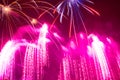 splashes of pink bright beautiful fireworks in the night sky on Royalty Free Stock Photo